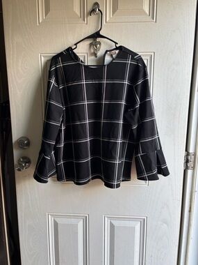 H&M Black Blouse with White Windowpane Stripes and wide sleeves.